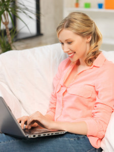 woman with laptop typing at home