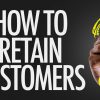 Hand writing the text: How To Retain Customers?