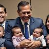 Featured_Elder-businessman-wearing-suit-and-tie-smiling,-holding-several-babies-in-his-arms,-each-babies-also-wearing-suit-and-tie,-corporate-board-room-setting,-photorealistic,-highly-detail